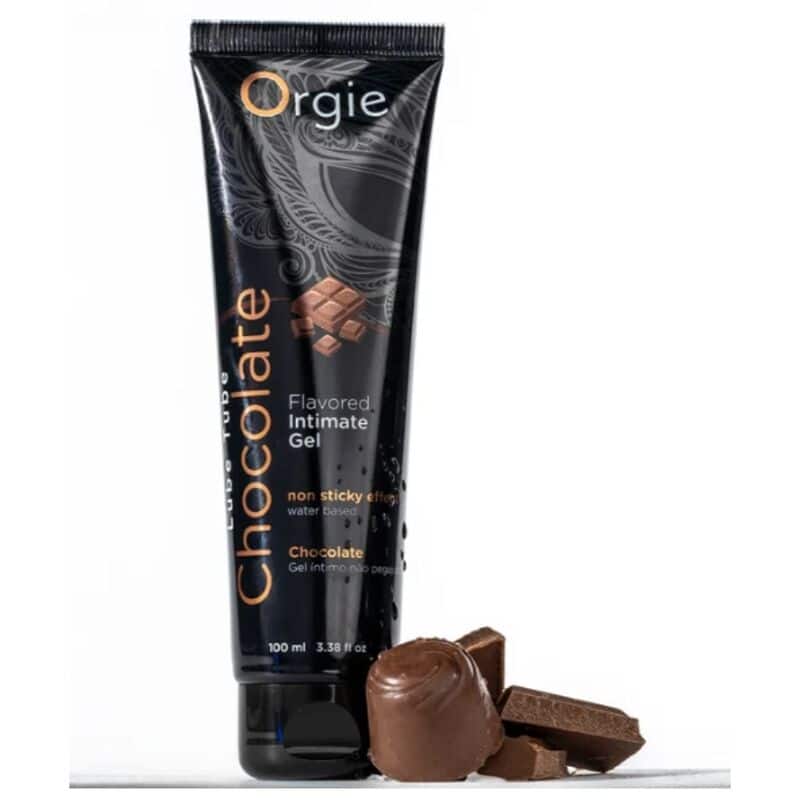 Tubo negro de gel íntimo de chocolate Orgie junto a piezas de chocolate